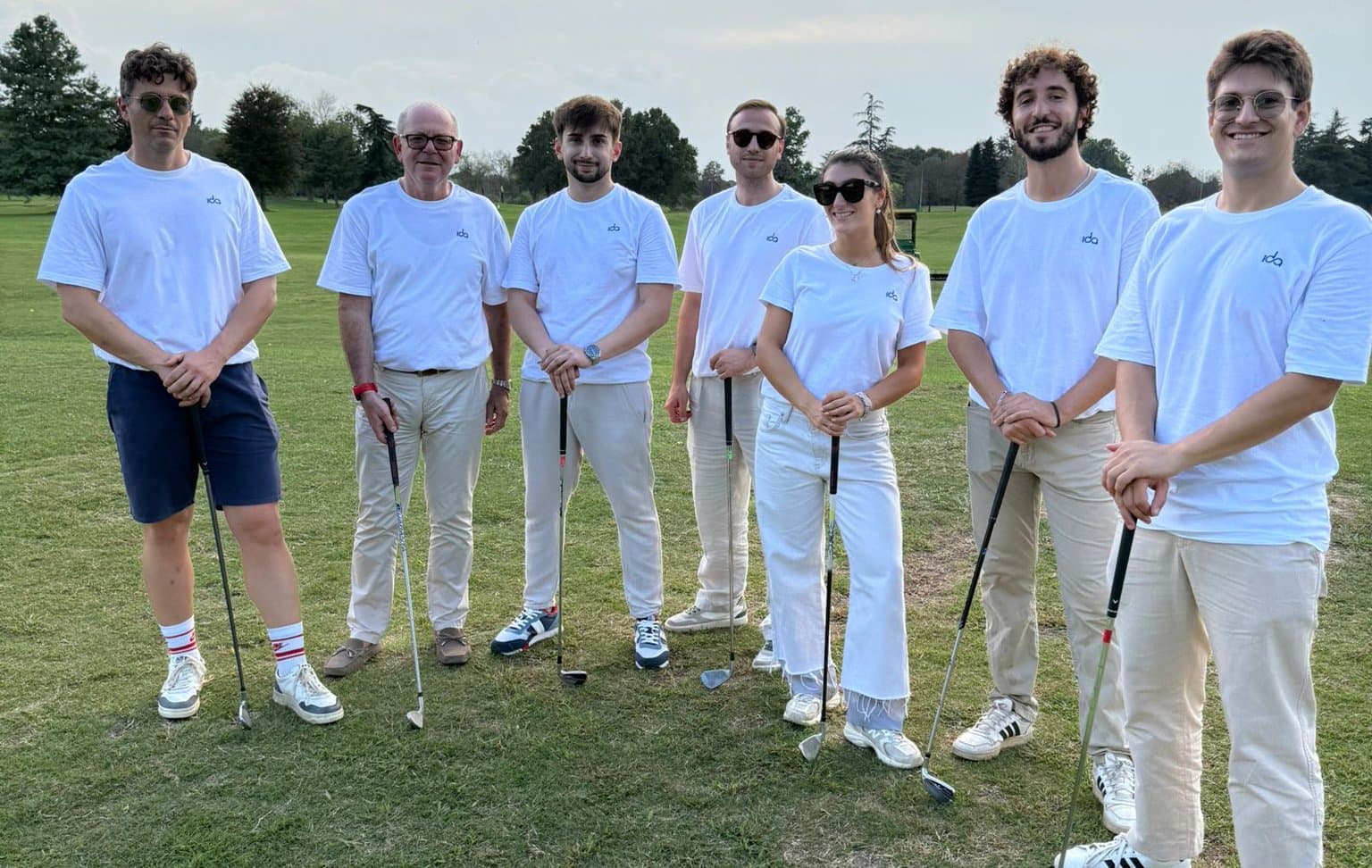 Seven members of the team playing golf, in Ida shirts